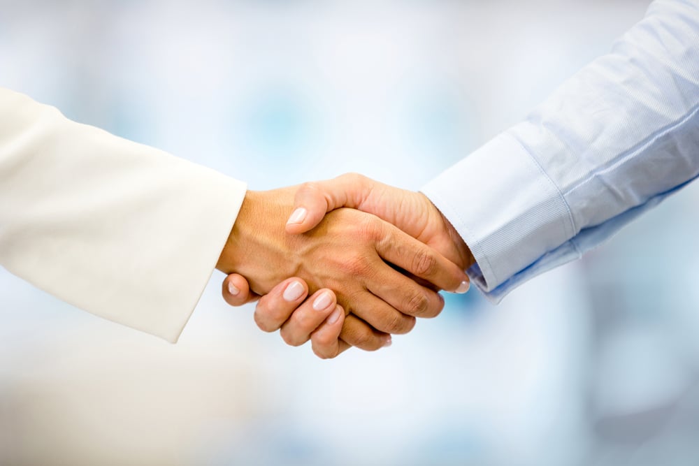Successful business people handshaking closing a deal Successful business people handshaking closing a deal